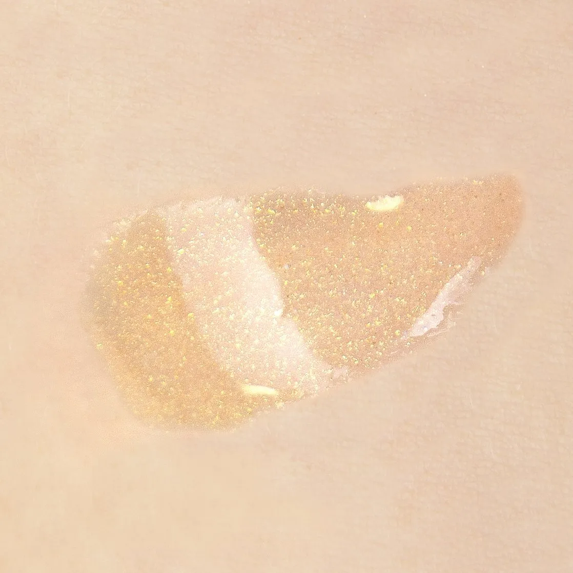 theBalm cosmetics PLUMP YOUR PUCKER® Lip Gloss Overstate - sheer light nude with golden glitter